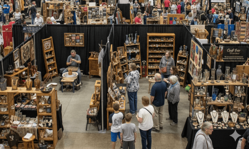 people exploring an indoor craft fair 