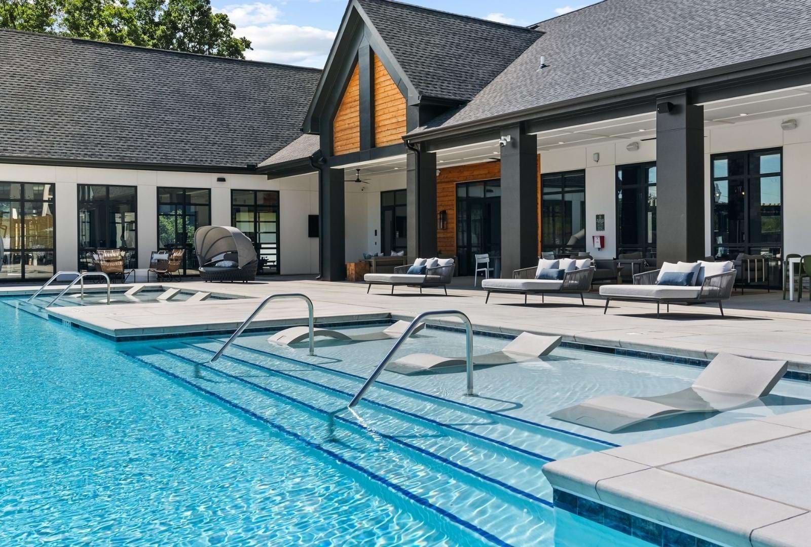 resort style pool with a building behind it